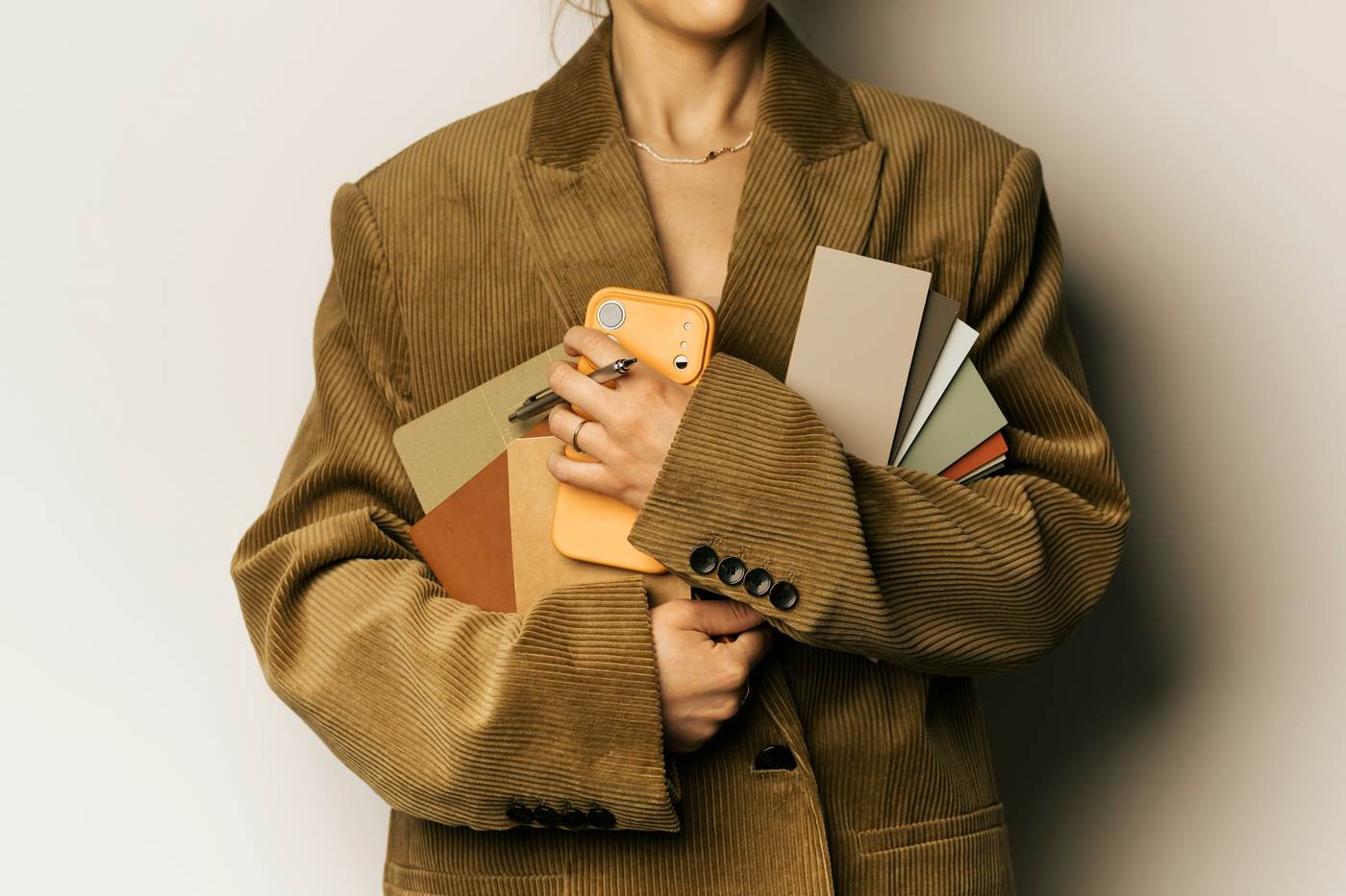 Person lying on a sofa scrolling a phone in low evening light