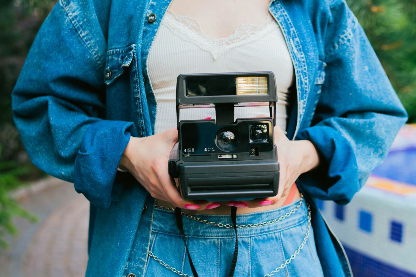 Hands holding a film camera — analogue attention
