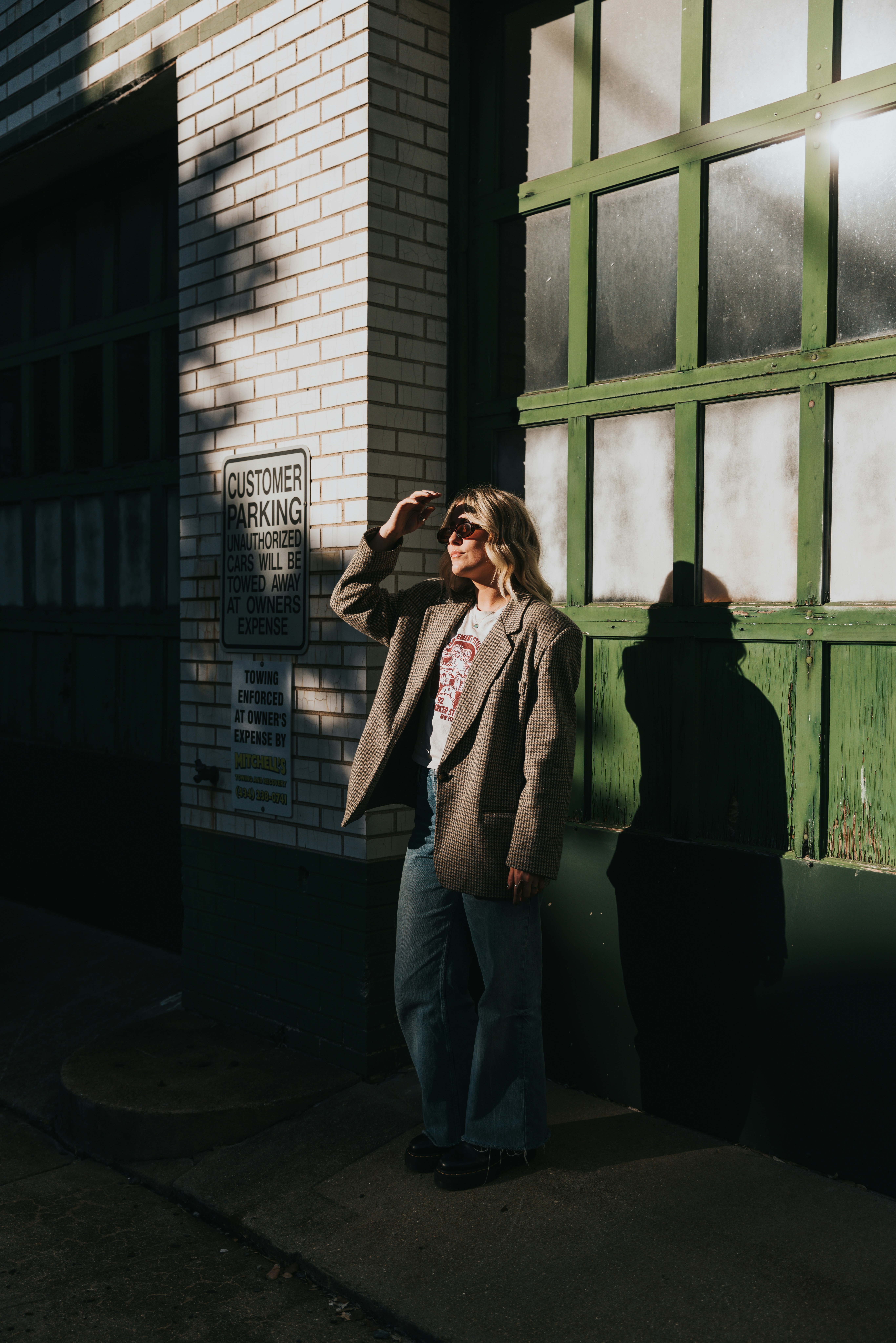 Someone sitting quietly by a window in the late afternoon, phone set down