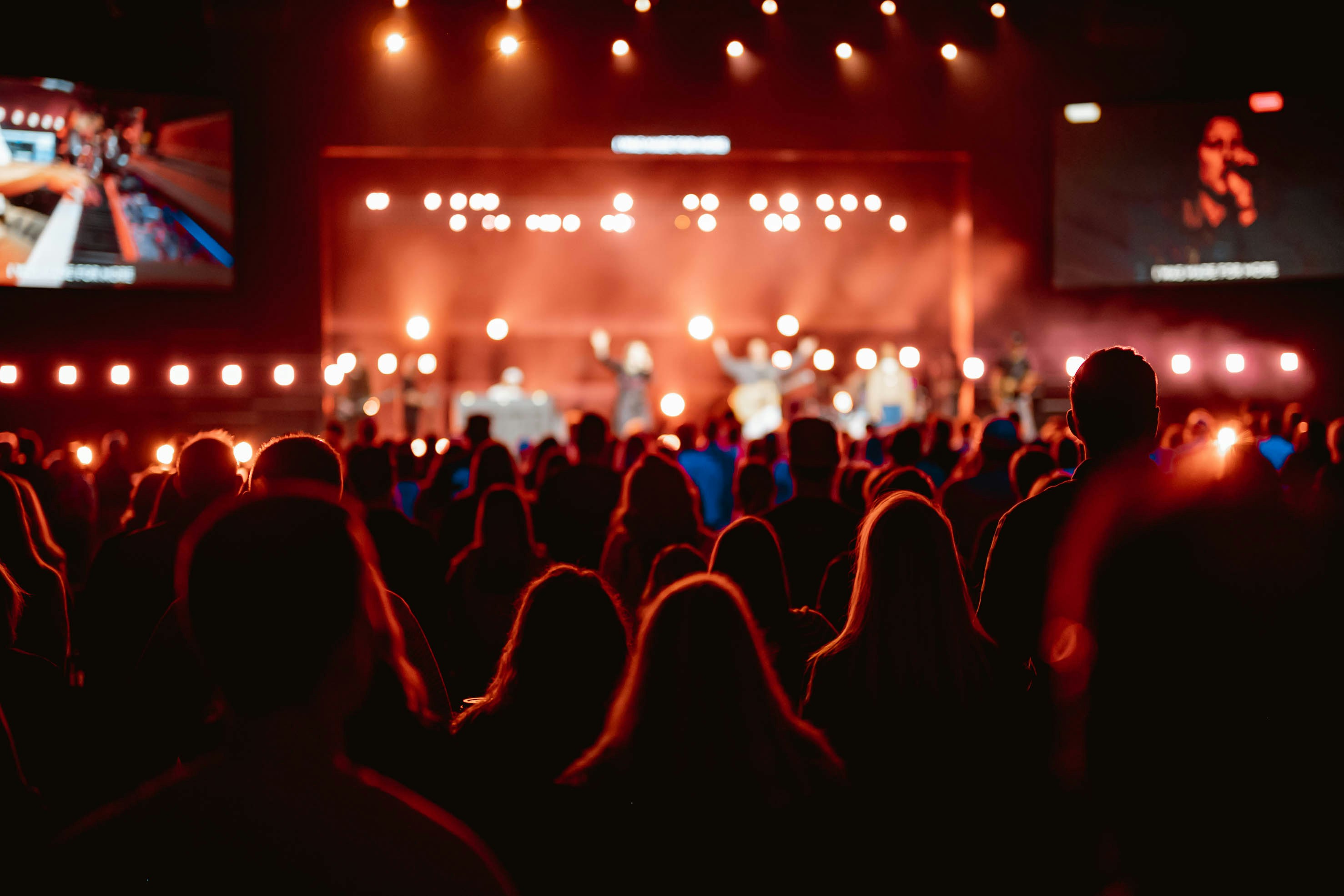 Young people at a live gig, hands in the air