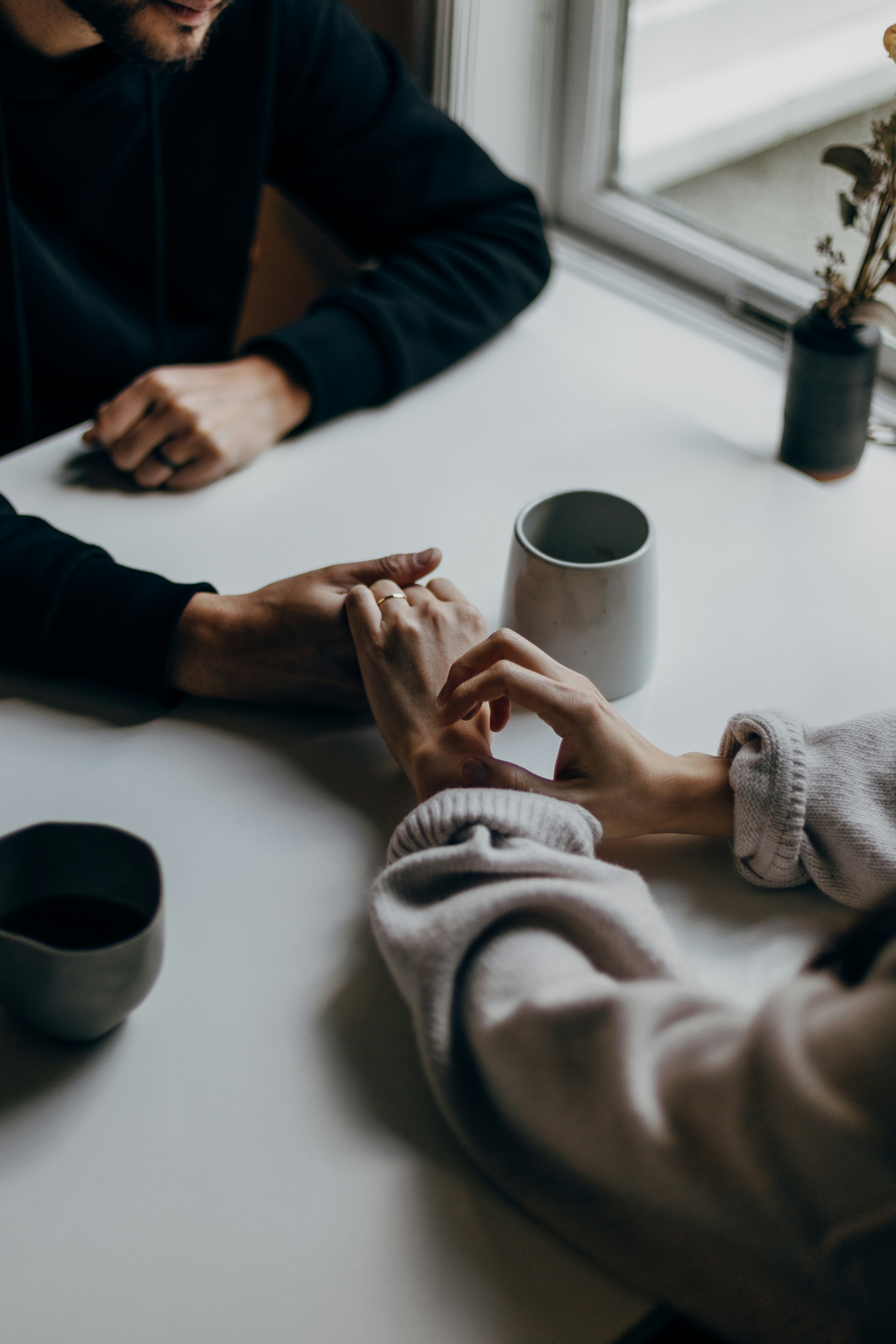 Two people talking over coffee